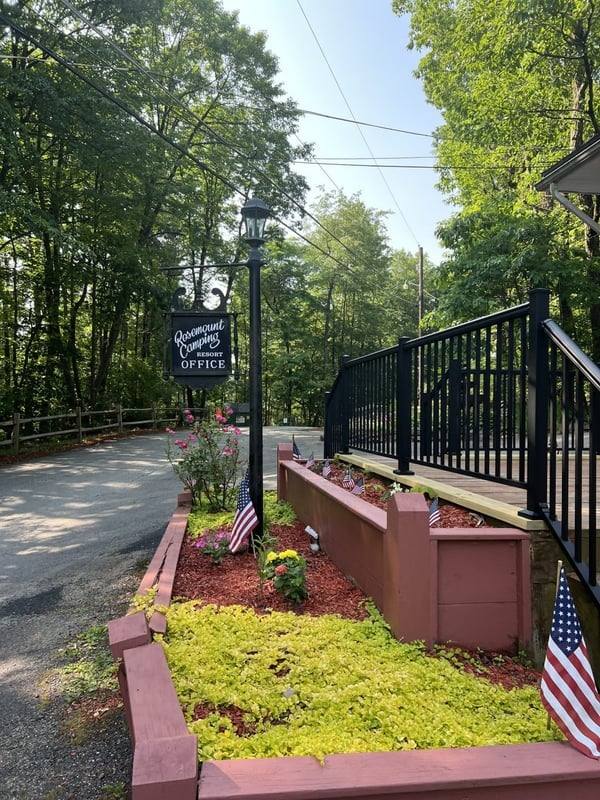 Rosemount office entrance with flower beds and American flags